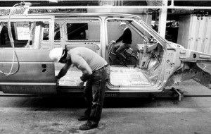 File photo of an autoworker installing a sliding door on a new Chrysler minivan in 1983 (Windsor Star)
